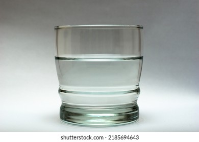 Glass Of Water Isolated On White Background. Half Full Half Empty Concept. 