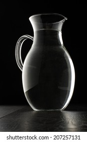 Glass Water Jug Isolated On The Black Background