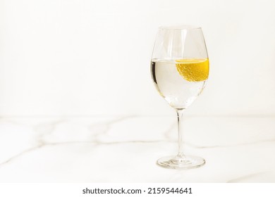 A Glass Of Water With Lemon On A Light Table For Healthy Life, Energy, Thermoregulation And Normalization Of Digestion