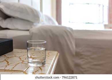 
A Glass Of Water On The Bedside In The Hotel Room