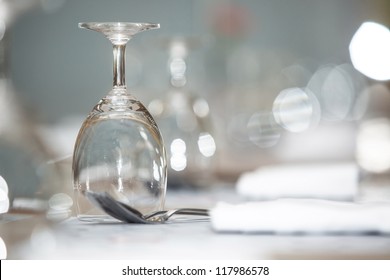 Glass of water on luxury table setting for dining, selective focus with bokeh background