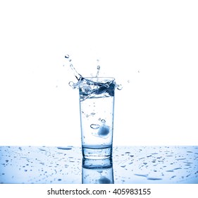 Glass of water on a table and splash