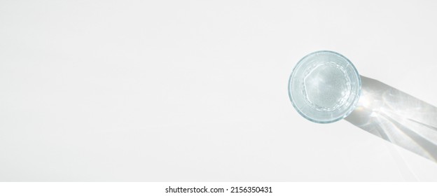 Glass Of Water On A White Background. Top View, Flat Lay. Banner