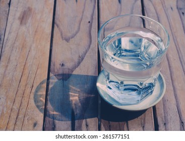 Glass Of Water On Wood Background