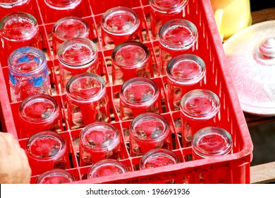 A glass of water in plastic crates