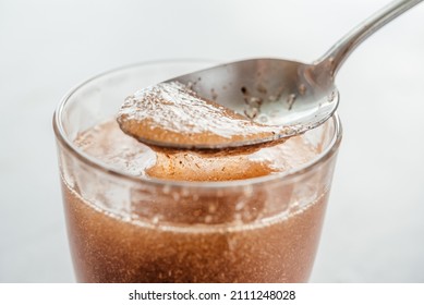 A glass of water soluble psyllium husk dietary fiber supplement, healthy diet morning routine - Shutterstock ID 2111248028