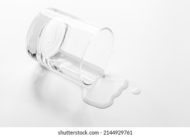 
A Glass Of Water Spilled On A White Table