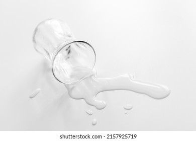 a glass of water spilled on a white table - Shutterstock ID 2157925719