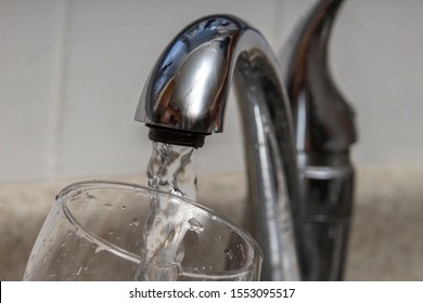 Glass At Water Tap And Filling Water With Lead Contamination