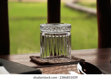 A glass of water is upside down on the dining table. - Powered by Shutterstock