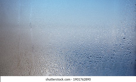 Glass with water vapor, fog, flow. a window with water drops. fogged glass  - Shutterstock ID 1901762890