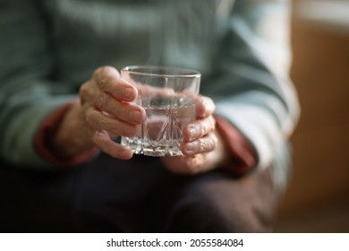 A Glass Of Water In The Wrinkled Hands Of An Elderly Woman, Grandmother Drinks Water, Health Care, The Benefits Of Drinking Water For An Old Man.
