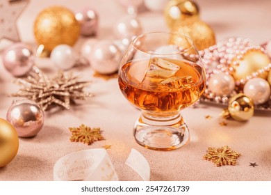 Glass of whiskey or bourbon with festive Christmas decoration on light beige background. New Year, Christmas and winter holidays whiskey mood concept - Powered by Shutterstock