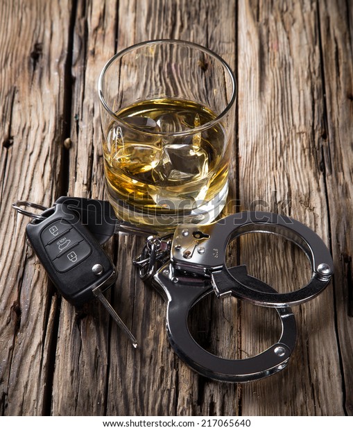 Glass of\
whiskey and car keys, drinking and\
driving