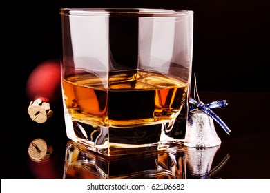 a glass of whiskey and Christmas decoration - Powered by Shutterstock