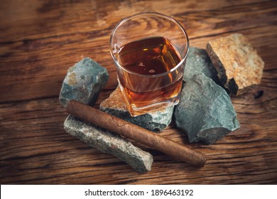 glass of whiskey and cigar on stone