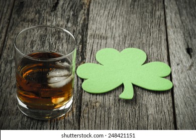 Glass of Whiskey and Clovers to celebrate St Patrick's Day - Powered by Shutterstock