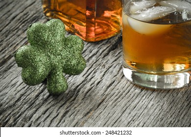 Glass of Whiskey and Clovers to celebrate St Patrick's Day - Powered by Shutterstock