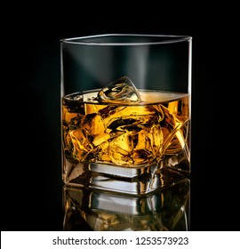 Glass Of Whiskey With Ice On Black Background 