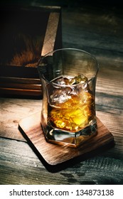 Glass Of Whiskey With Ice On Wooden Lining And Planking Texture