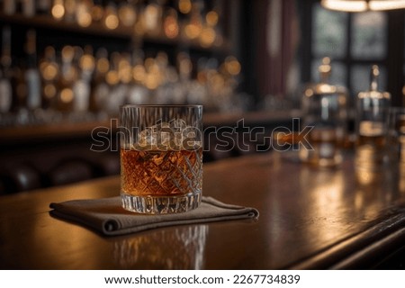 a glass of whiskey on the bar in front of the bar