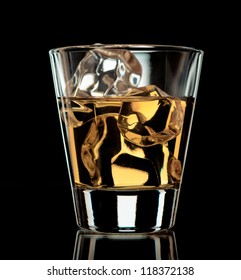 Glass Of Whiskey On The Rocks On Black Background