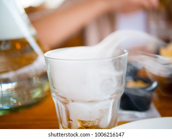 A glass of whiskey with smoke inside - Shutterstock ID 1006216147