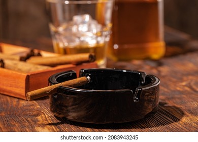 Glass Of Whisky And Lighted Cigar In An Ash Tray