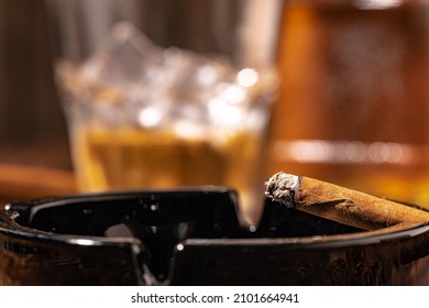 Glass Of Whisky And Lighted Cigar In An Ash Tray