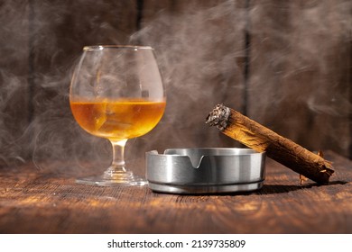 Glass Of Whisky And Lighted Cigar In An Ash Tray