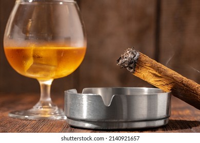 Glass Of Whisky And Lighted Cigar In An Ash Tray