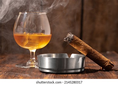 Glass Of Whisky And Lighted Cigar In An Ash Tray