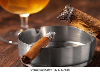 Glass Of Whisky And Lighted Cigar In An Ash Tray