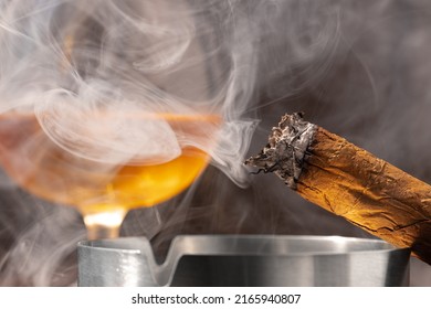 Glass Of Whisky And Lighted Cigar In An Ash Tray