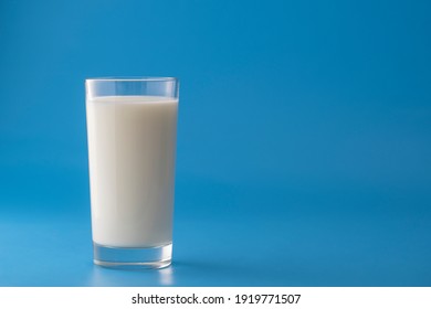 Glass of white milk isolated on blue background, close up. Dairy product concept, copy space - Powered by Shutterstock