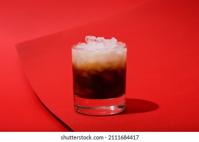 Glass Of White Russian Cocktail On Red Background