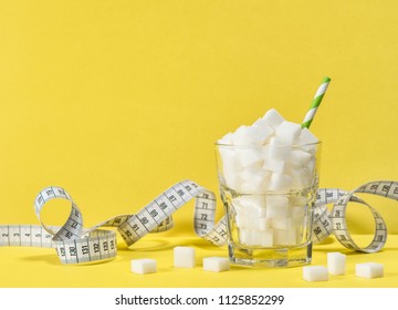 Glass With White Sugar Cubes And Measuring Tape. Weight Control, Diet And Detox Concept