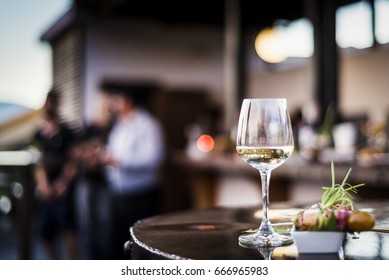 Glass Of White Wine With Gourmet Food Tapa Snacks In Outdoors Bar At Sunset