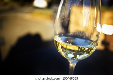 A Glass Of White Wine In An Isolated Background.