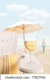 Glass Of White Wine On Adirondack Chair At The Beach