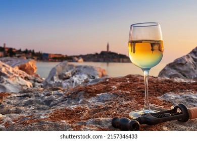 Glass Of White Wine On The Background Of Rovinj Town, Croatia