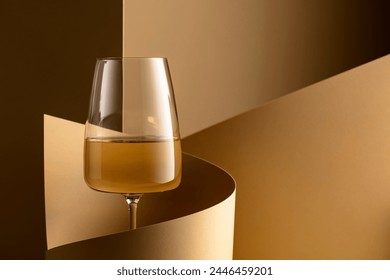 Glass of white wine on a beige background. Copy space. - Powered by Shutterstock