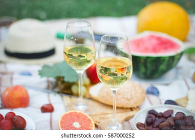 Glass Of White Wine On Picnic Table.  Dining People Concept.