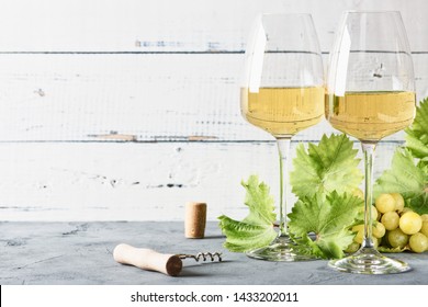 Glass Of White Wine On Vintage Wooden Table. Light Background