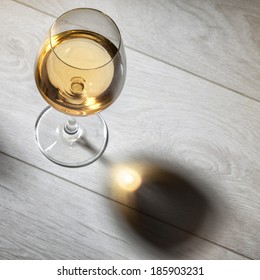 Glass Of White Wine On Wooden Table. Top View