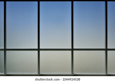The glass window of building with white aluminum framework, Blue tone as background.