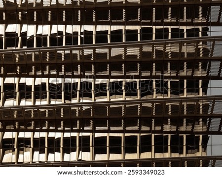A glass windows of a building with windows reflections.