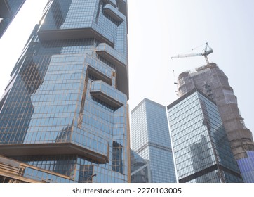 Glass windows of contemporary business building with blue sky and other building reflection close-up. Modern architecture with blue sky. - Shutterstock ID 2270103005