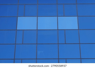 Glass windows rectangular shapes pattern on modern office building facade.