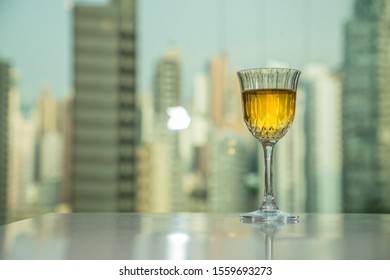 A Glass Of Wine With Buildings In Central, Hong Kong In Background